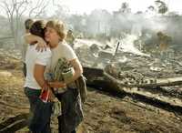Barbara Pointer y su hija se abrazan frente a los restos aún humeantes de su casa destruida por el fuego en la localidad californiana de Montecito