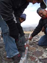 Trabajadores durante la instalación, hace unos días, de canaletas de aluminio mediante la perforación de la piedra prehispánica